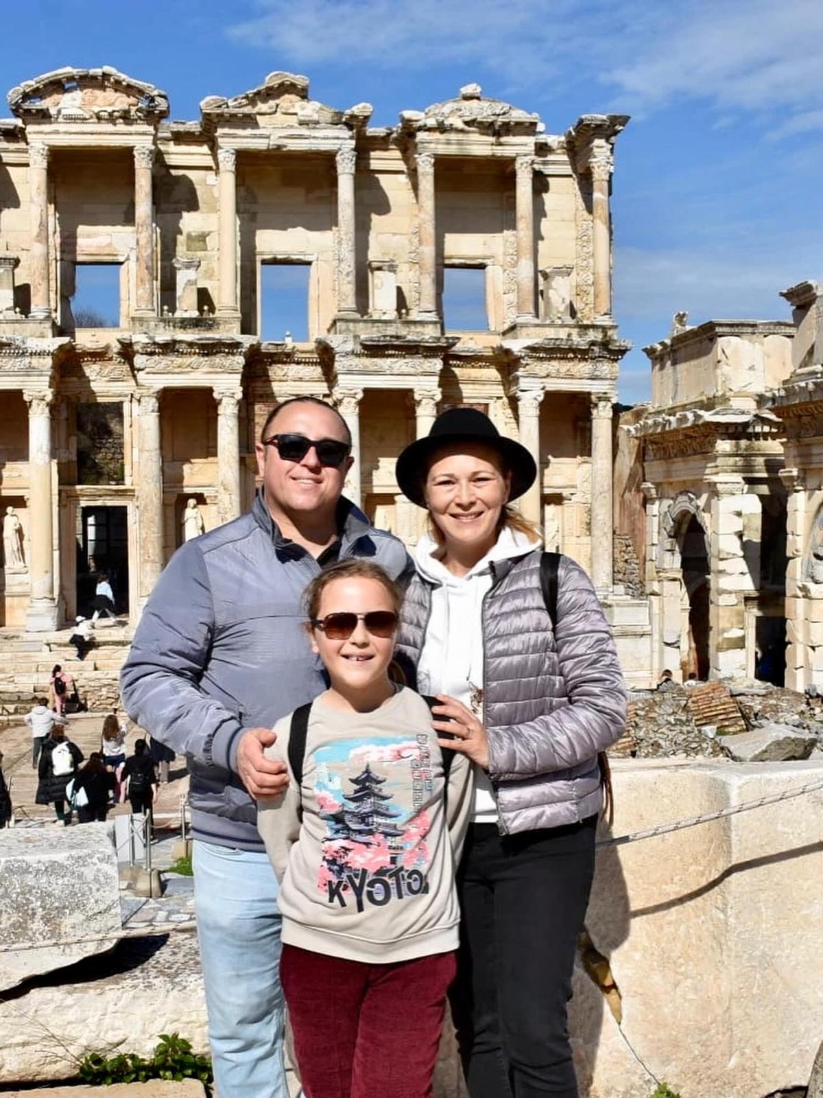 Ephesus tour guide Hasan Gülday with his family in front of the Library of Celsus in Ephesus