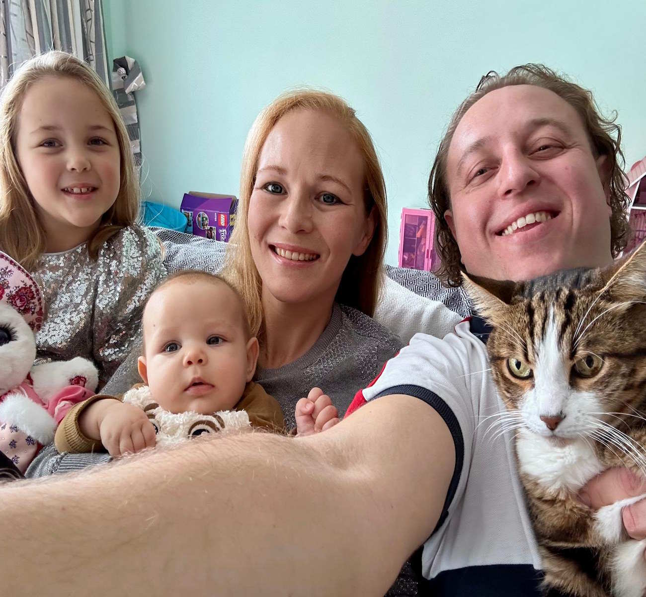 Hasan Gülday, Ephesus tour guide and creator of ephesuscats.com, at home with his family and their tabby cat